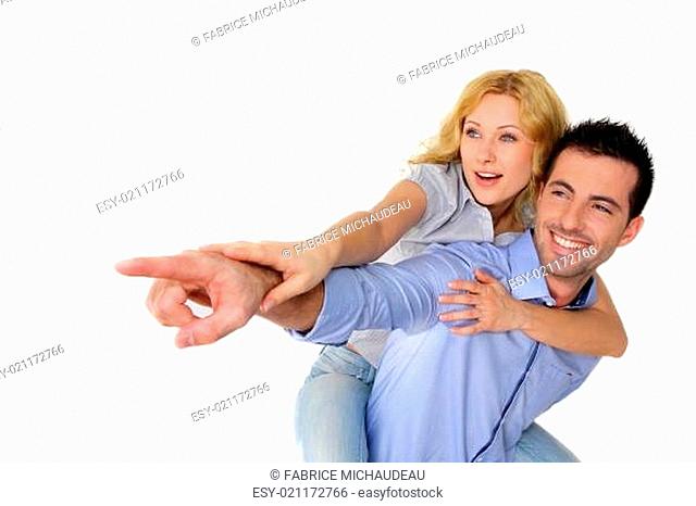 Cheerful couple pointing at one side