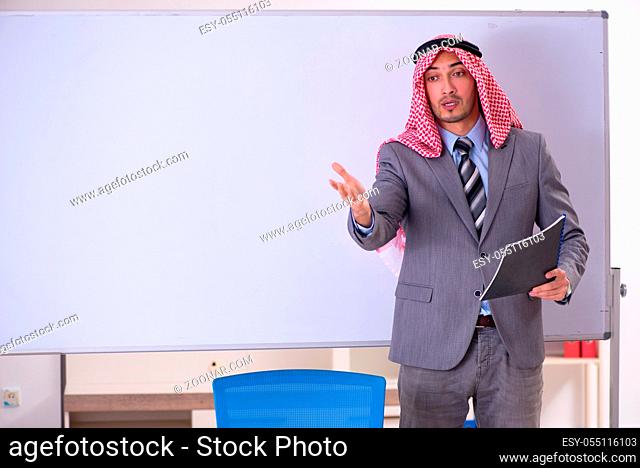 Young handsome arab teacher wearing suit