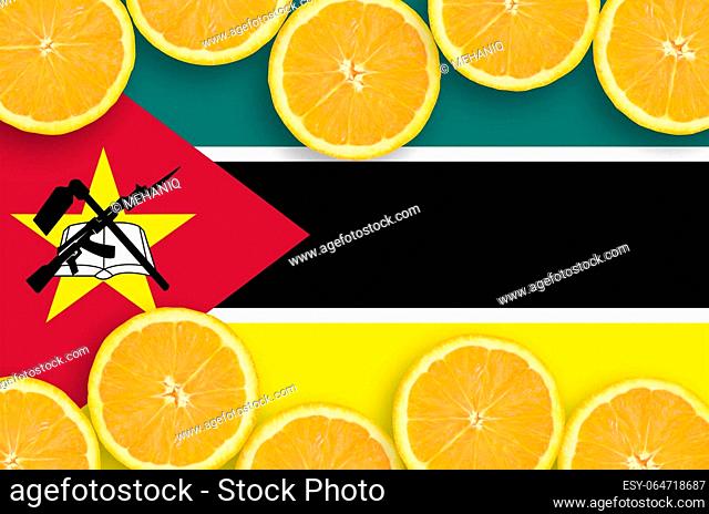 Mozambique flag in horizontal frame of orange citrus fruit slices. Concept of growing as well as import and export of citrus fruits