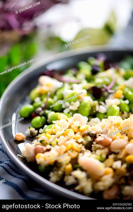 Wholefood vegetarian salad with edamame soybeans, quinoa and Kamut