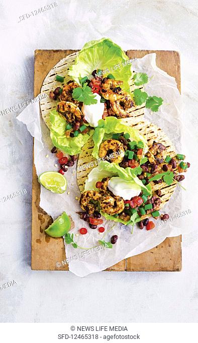 Spicy prawn tacos with bean salad