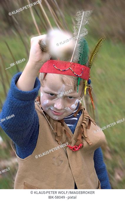 Dressed up boy plays playing Indian Native American
