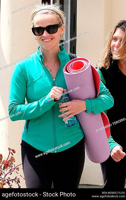Reese Witherspoon carrying a yoga mat while leaving a gym with a friendLos Angeles, California - 09.04.09