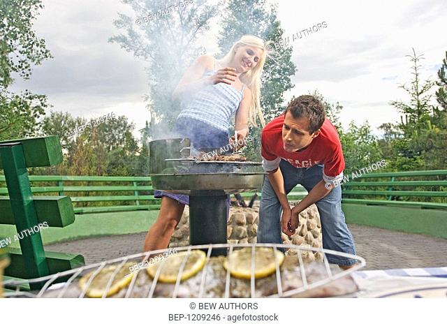 Couple making barbecue
