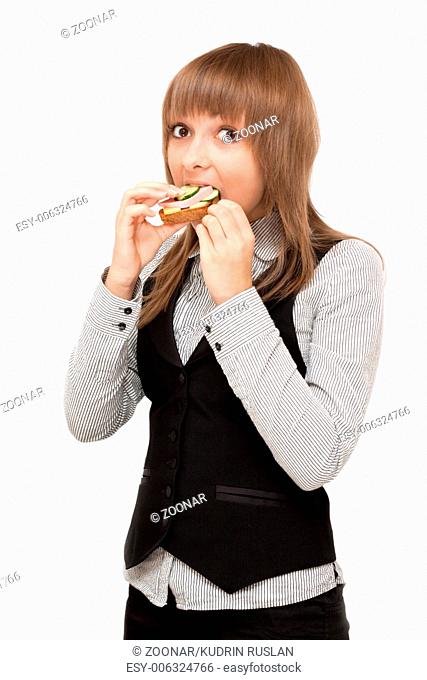 Young girl eats sandwich