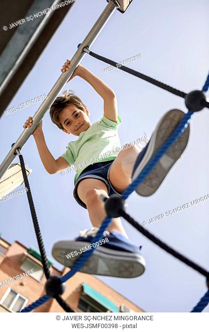 Portrait of smiling little girl on jungle gym