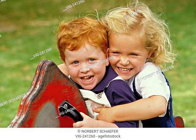 portrait, playing ground scene, strawberry blond curly girl and redheaded boy with big blue eyes, 3-4 years, wearing white and blue dresses