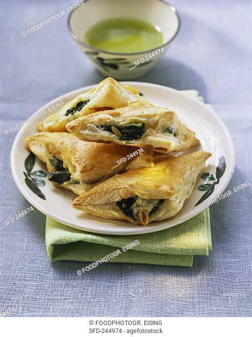 Spinach and mozzarella triangles with pine nuts