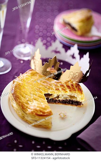 Puff pastry chocolate cake, sliced, decorated with a crown