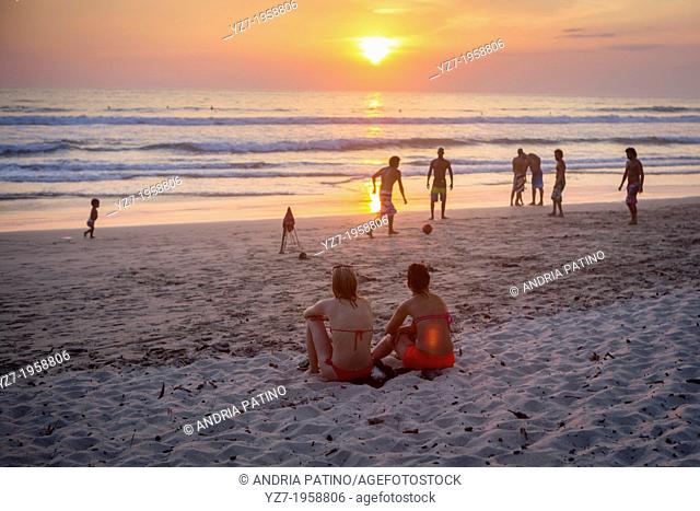 Locals and visitors gather at Santa Teresa beach to watch the sunset, Costa Rica