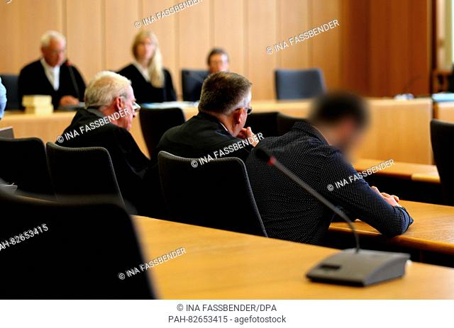 The accused Khaleqy S (R) sits next to his legal team at the beginning of a murder trial at the Bochum district court in Bochum, Germany, 10 August 2016