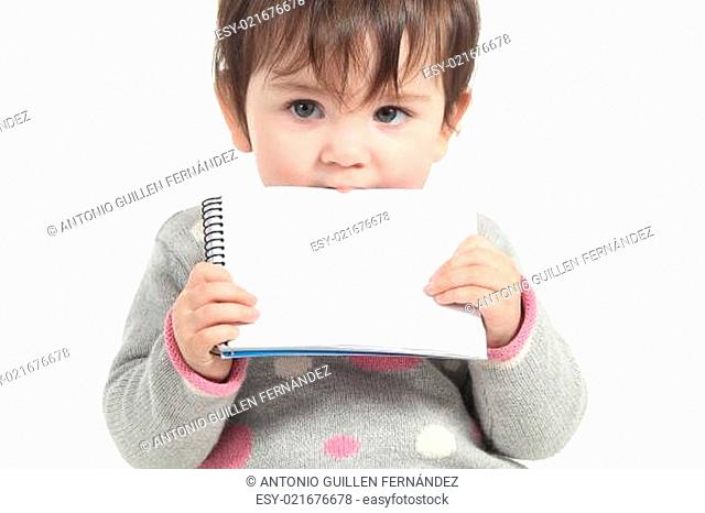 Baby biting a blank notebook