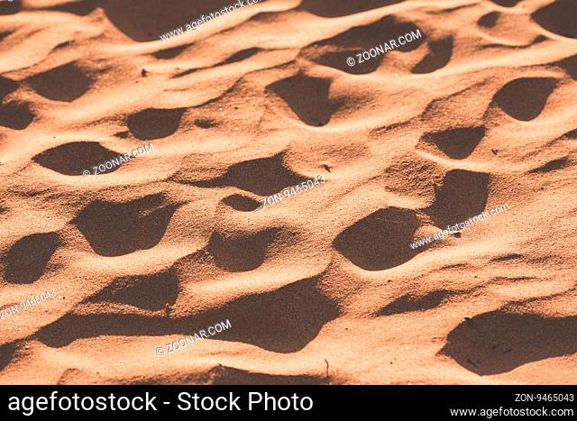 Texture of beach sand is photographed close-up