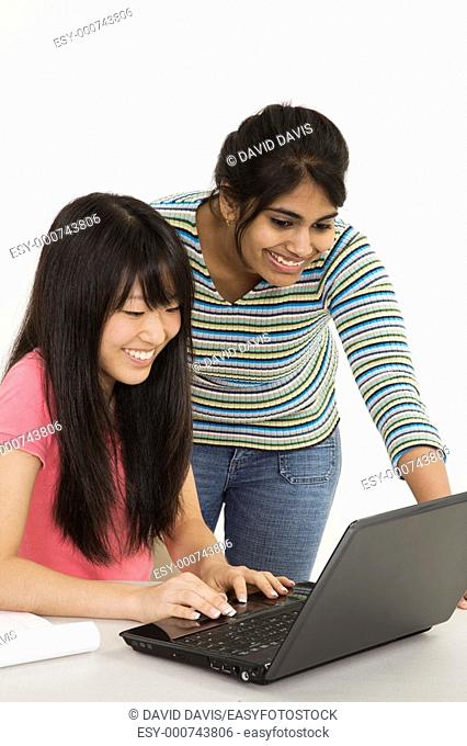 Asian and East Indian teenagers working on a the laptop computer