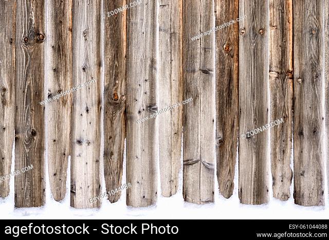 Old vintage wood wall with snow. Winter and christmas background. Wood planks, boards are old with a beautiful rustic look