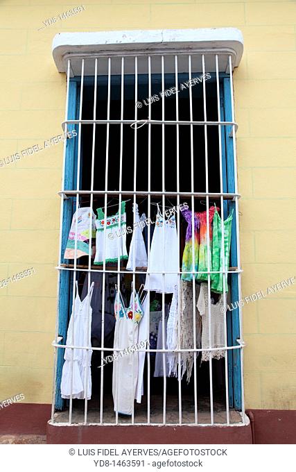 Typical window of the historic city of Trinidad and sale of clothing, Cuba