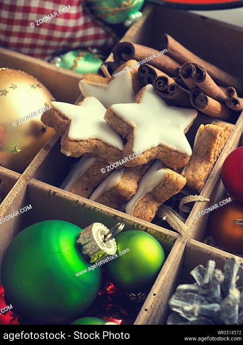 Colorful Christmas decoration items in a wooden box, close up shot