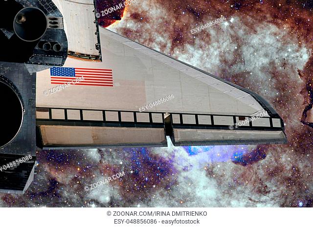 Space Shuttle flight over space nebula. Elements of this image furnished by NASA