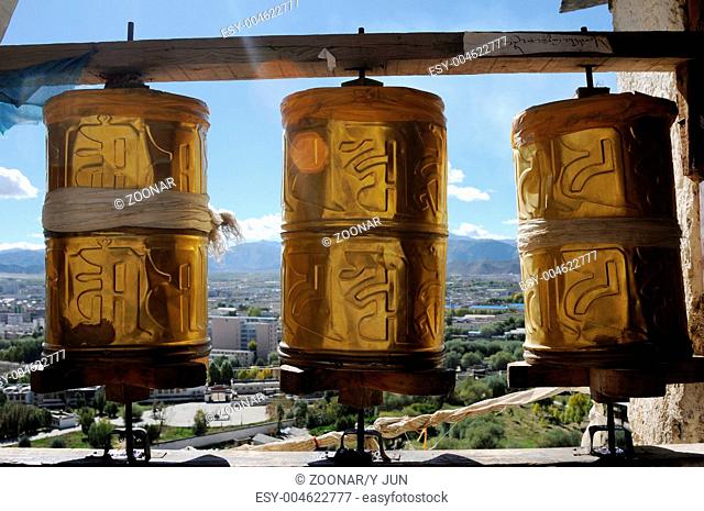 Golden prayer wheels in a historic Tibetan lamasery