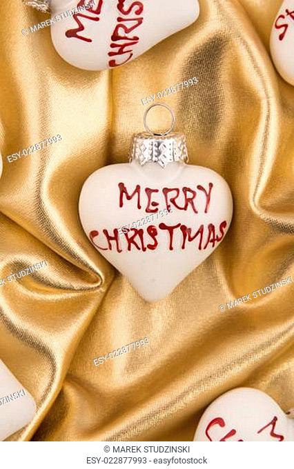 A christmas tree decoration on a golden stuff