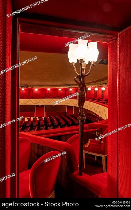 View from the boxes of the Teatro Manzoni, covered with red velvet upholstery and the Cariatide lamp, made of bronze. Milan (Italy), December 29th