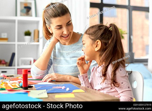 daughter with mother making applique at home