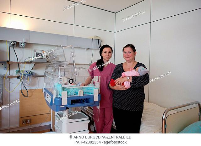 Pediatric nurse, Melanie Seipelt (L) takes care of Tanja Hinkelmann and her daughter Johanna (born on 27 August 2013) in a room of the new interdisciplinary...