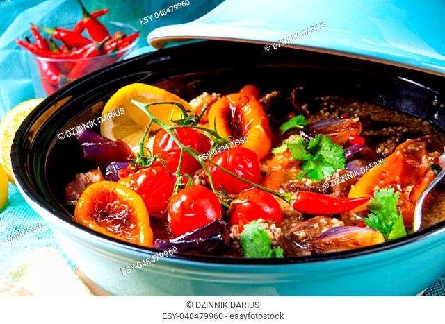 Tasty spicy beef with various vegetables cooked in tagine