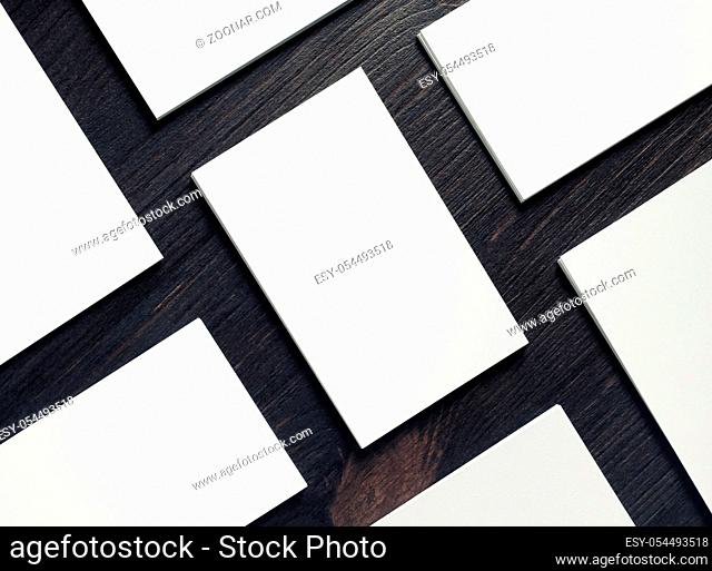 Many blank white business cards on wooden background. Responsive design template. Flat lay