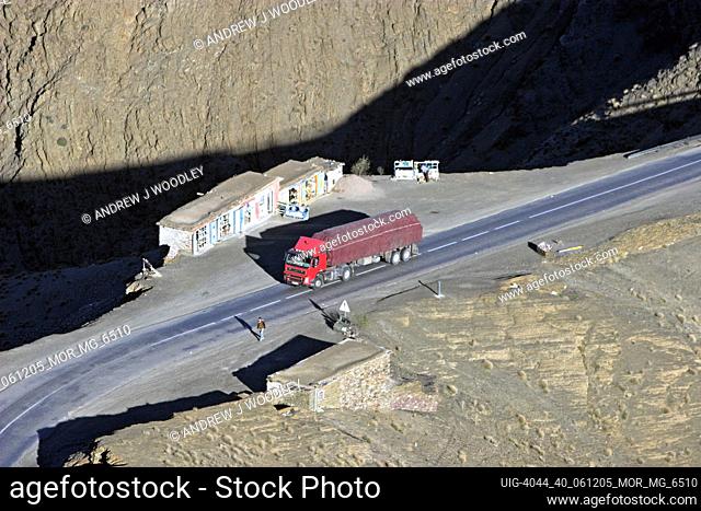 Red truck crawls up Tizi-n-Tichka Pass High Atlas mountains Morocco