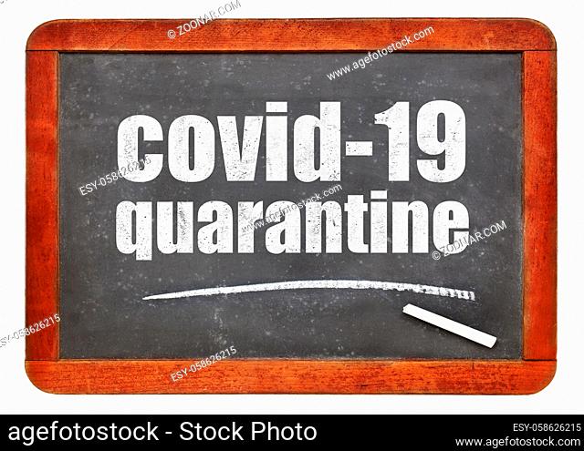 covid-19 quarantine blackboard sign - white chalk text on a vintage slate chalkboard, coronavirus outbreak concept