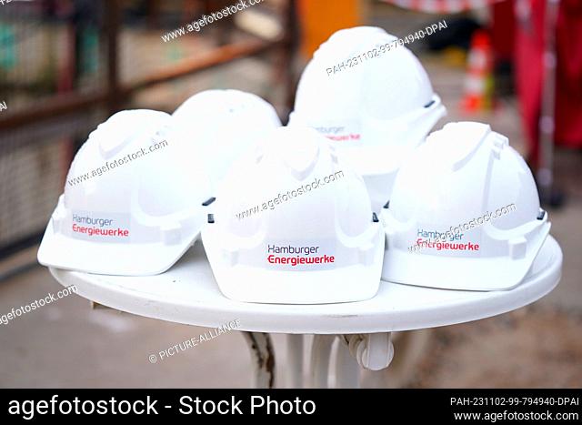 02 November 2023, Hamburg: Construction workers' helmets with the lettering ""Hamburger Energiewerke"" lie on a table before the start of drilling for Hamburg's...
