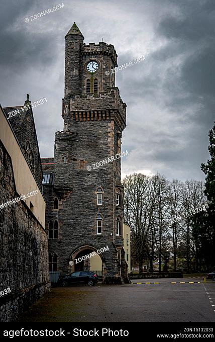 FORT AUGUSTUS, SCOTLAND, DECEMBER 17, 2018: The Abbey Highland Club clock tower, full of mold and lichen in its stone walls