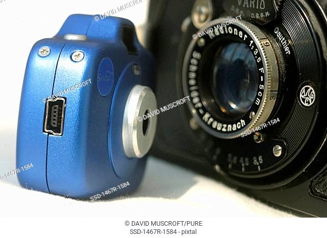 Close-up of an analogue camera and a digital camera