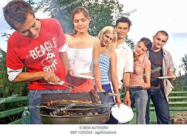 Friends making barbecue
