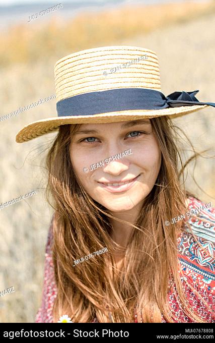 Portrait of a young woman in a straw hat