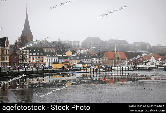 17 February 2021, Schleswig-Holstein, Flensburg: View across the harbour tip to some historic buildings in the city centre
