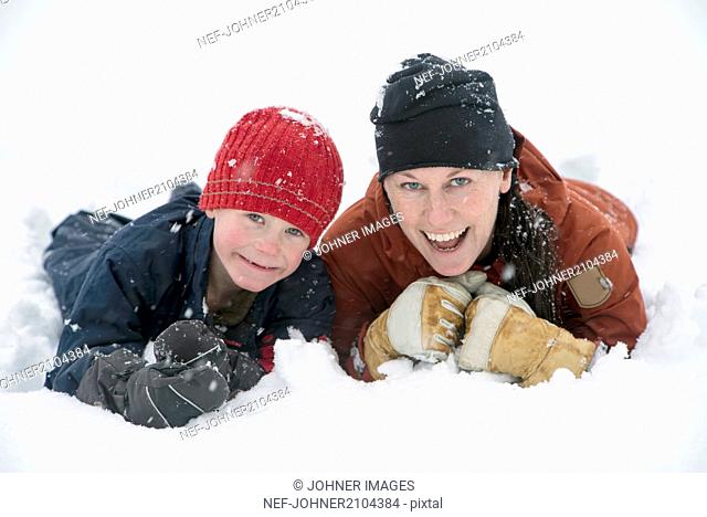 Mother with son on snow