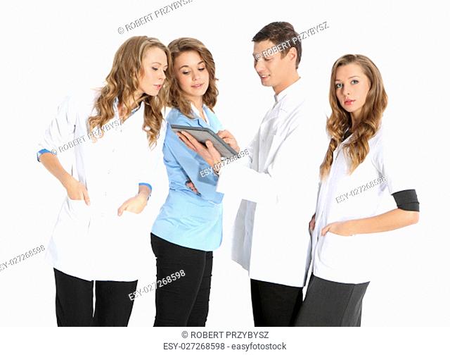 happy doctors in hospital. a team of young doctors. four young attractive doctors in white, blue on white aprons