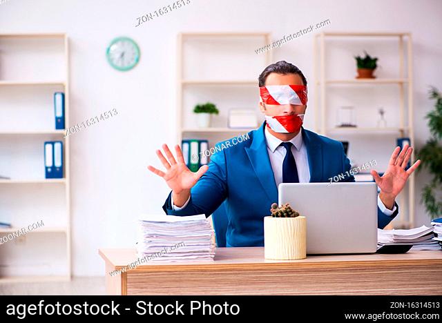 Mouth and eyes closed employee working in the office