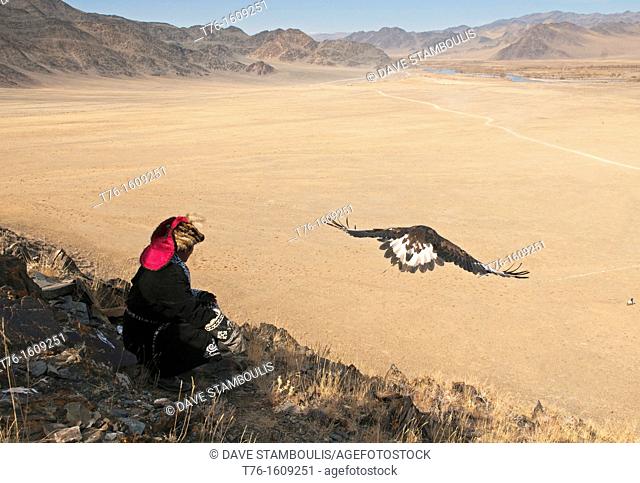 Kazakh eagle hunter sends out his golden eagle to fly in the Altai Region of Bayan-Ölgii in Western Mongolia