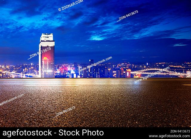 modern building in downtown of chongqing at twilight on view from empty asphalt road