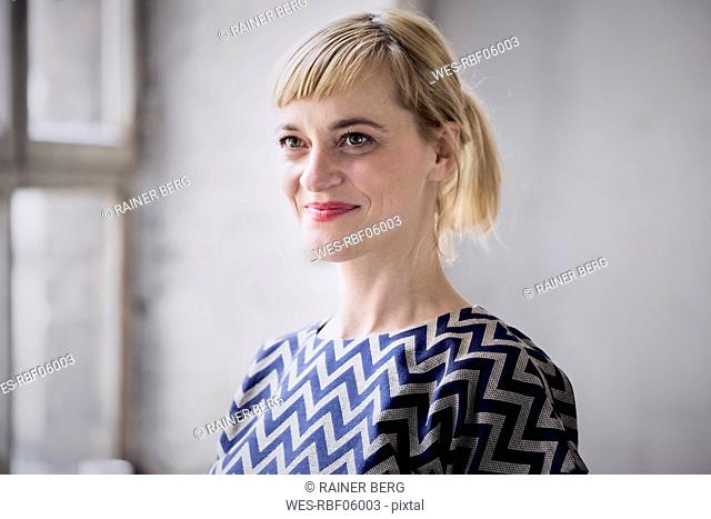 Portrait of happy blond businesswoman
