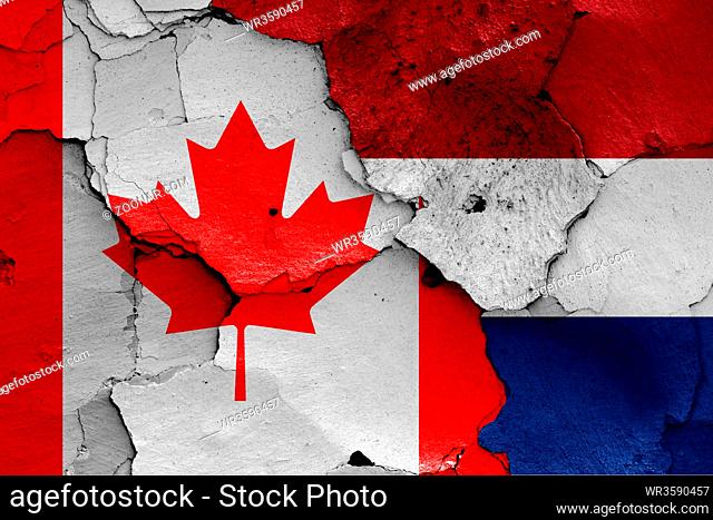 flags of Canada and Netherlands painted on cracked wall
