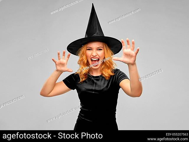 scary woman in black halloween costume of witch