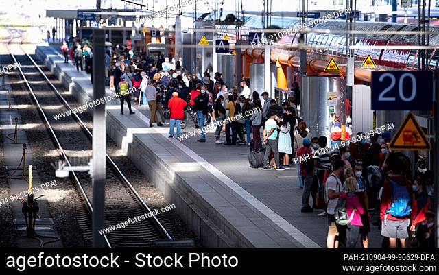 04 September 2021, Bavaria, Munich: Travellers stand on a platform at the main station. The train drivers' union GDL has called on its members to strike at...
