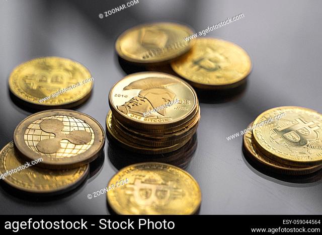 Stack of golden Titan bitcoin coin with a lot of bitcoins coins on a table. Virtual cryptocurrency concept. Mining of bitcoins online bussiness