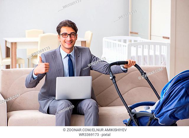 Businessman looking after newborn baby at home and teleworking