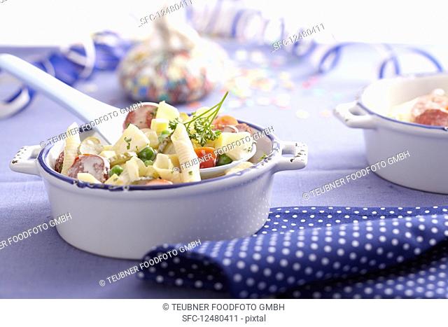 Penne pasta salad with pineapple and mayonnaise-yoghurt dressing in a mini baking dish