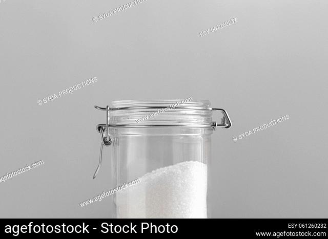 close up of sea salt glass jars on grey background